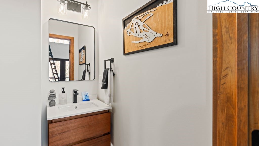 114 Windridge Road Beech Mountain, NC 28604 - Photo 14 of 49 a bathroom with a sink and a mirror