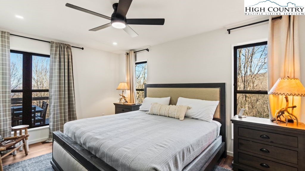 114 Windridge Road Beech Mountain, NC 28604 - Photo 15 of 49 a bedroom with a large bed and a window