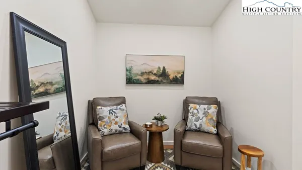 a living room with furniture and next to a window