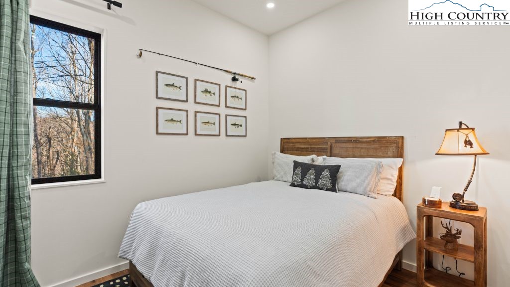 114 Windridge Road Beech Mountain, NC 28604 - Photo 20 of 49 a bedroom with a bed and wooden floor