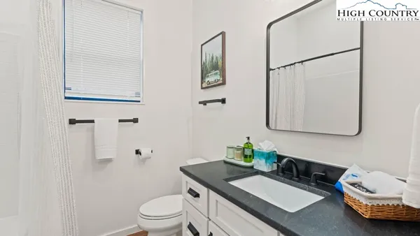 a view of a hallway with wooden floor and a potted plant