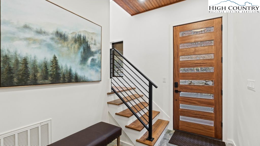114 Windridge Road Beech Mountain, NC 28604 - Photo 25 of 49 a view of a hallway with wooden floor and a potted plant