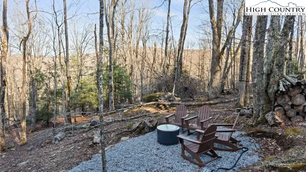 a view of backyard with table and chairs and potted plants