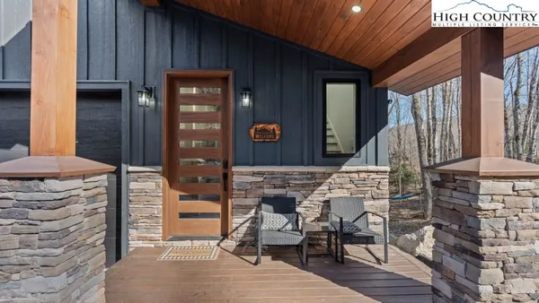 a view of a balcony with furniture and wooden floor