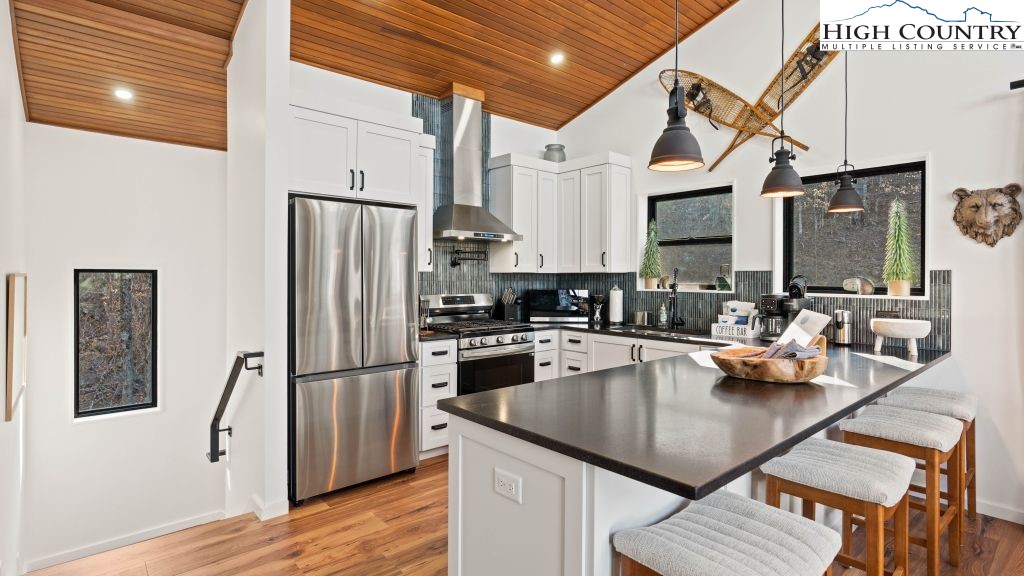 114 Windridge Road Beech Mountain, NC 28604 - Photo 6 of 49 a kitchen with stainless steel appliances granite countertop a sink refrigerator and cabinets