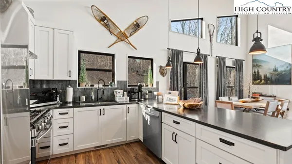 a open kitchen with white cabinets and sink
