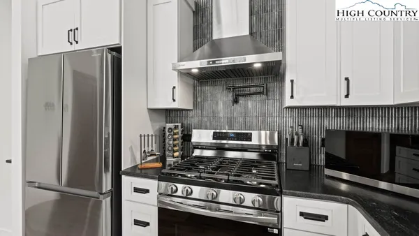 a kitchen with stainless steel appliances granite countertop a stove and a refrigerator