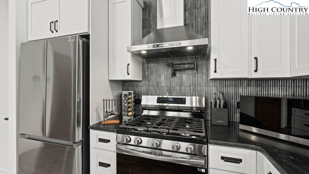114 Windridge Road Beech Mountain, NC 28604 - Photo 9 of 49 a kitchen with stainless steel appliances granite countertop a stove and a refrigerator