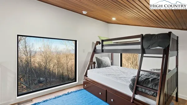 a bed sitting in a bedroom next to a window
