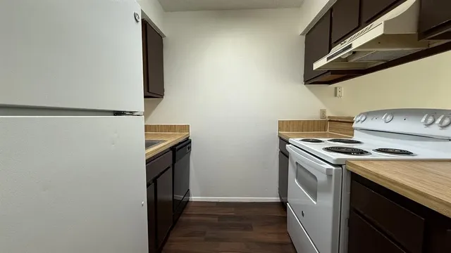 a kitchen with a stove and a refrigerator