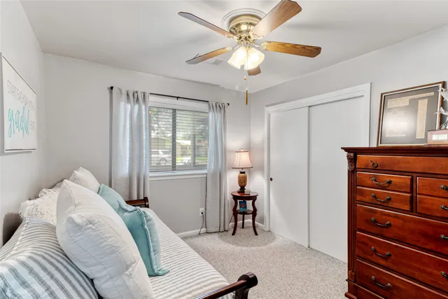 a bedroom with a bed and a book shelf