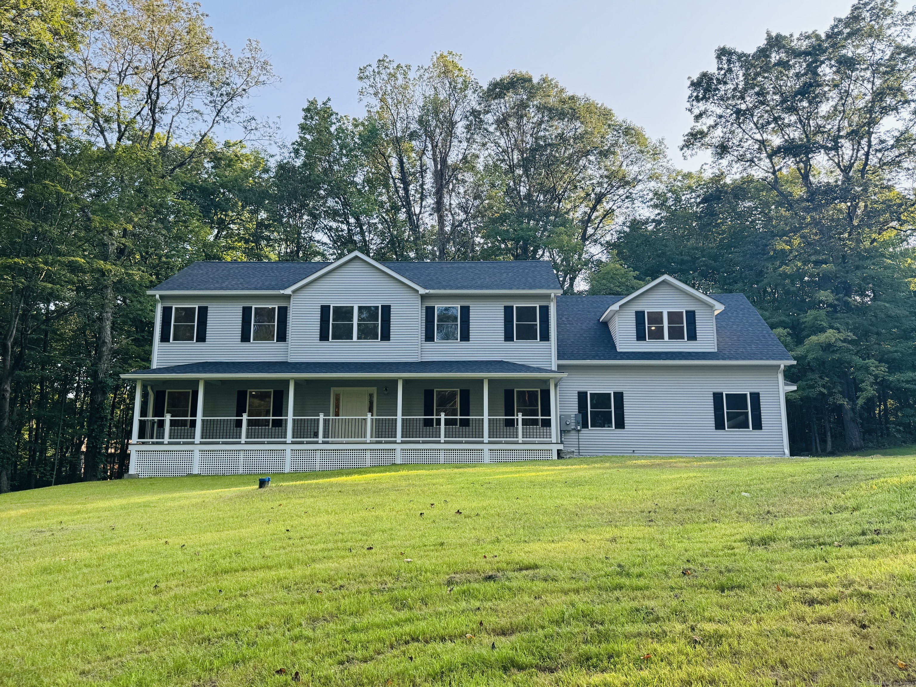 a house with tall trees in the background
