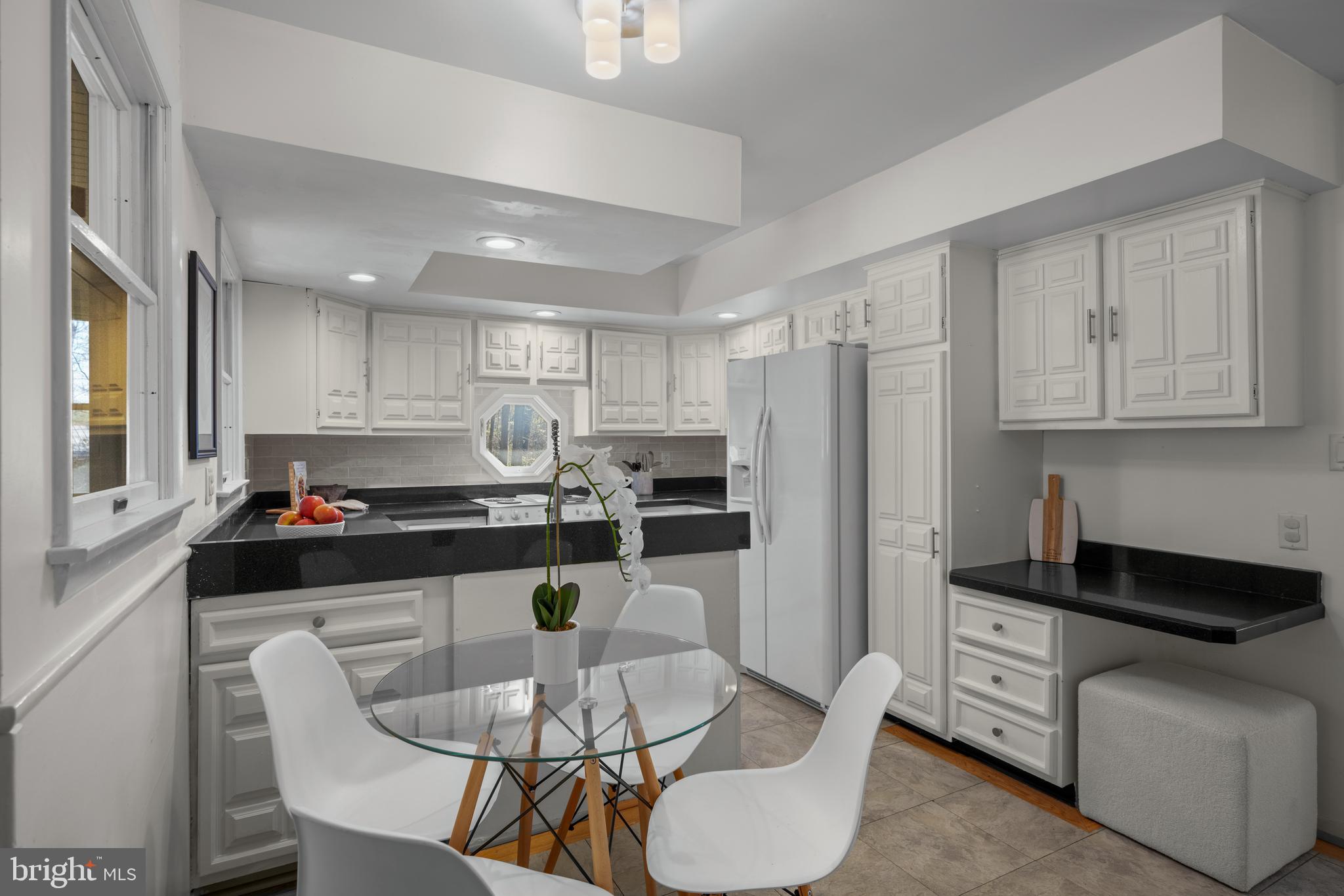932 Western Chapel Road Westminster, MD 21157 - Photo 13 of 48 a kitchen with stainless steel appliances granite countertop a stove a refrigerator a kitchen island a dining table and chairs