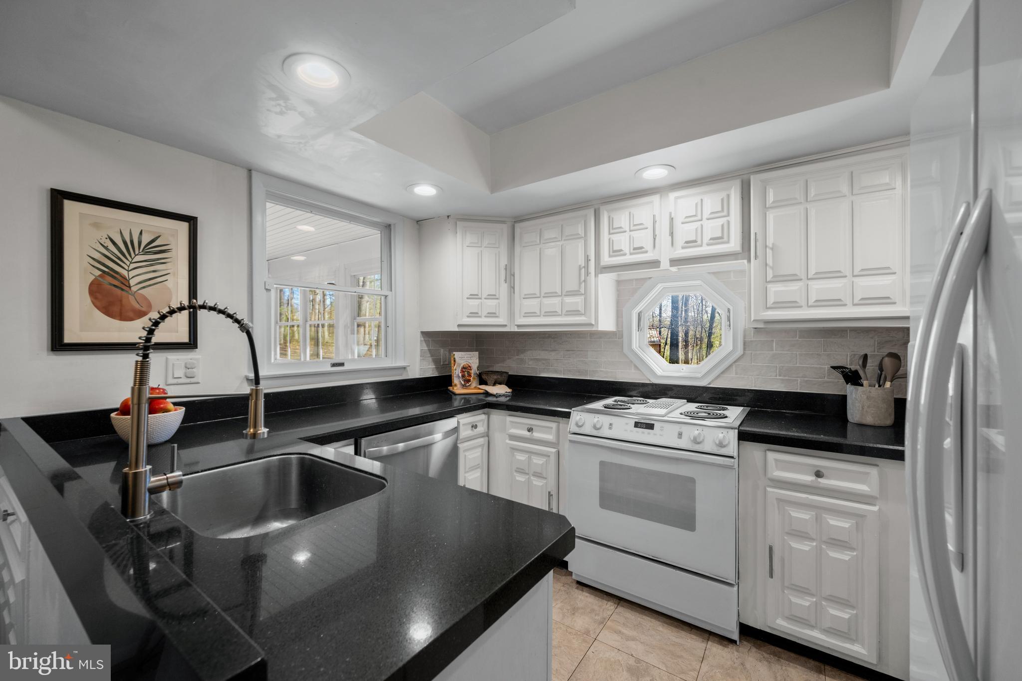 932 Western Chapel Road Westminster, MD 21157 - Photo 15 of 48 a kitchen with granite countertop a sink stainless steel appliances and cabinets