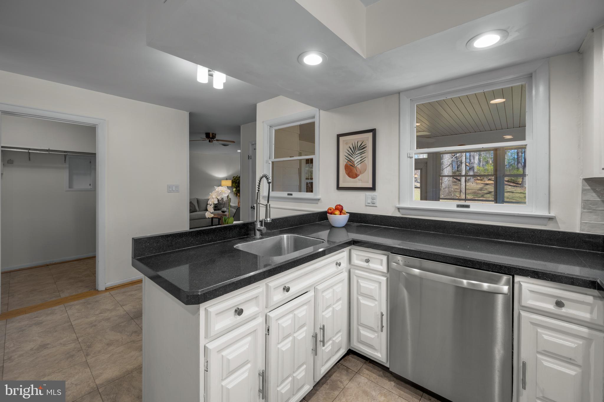 932 Western Chapel Road Westminster, MD 21157 - Photo 16 of 48 a kitchen with granite countertop white cabinets and white appliances