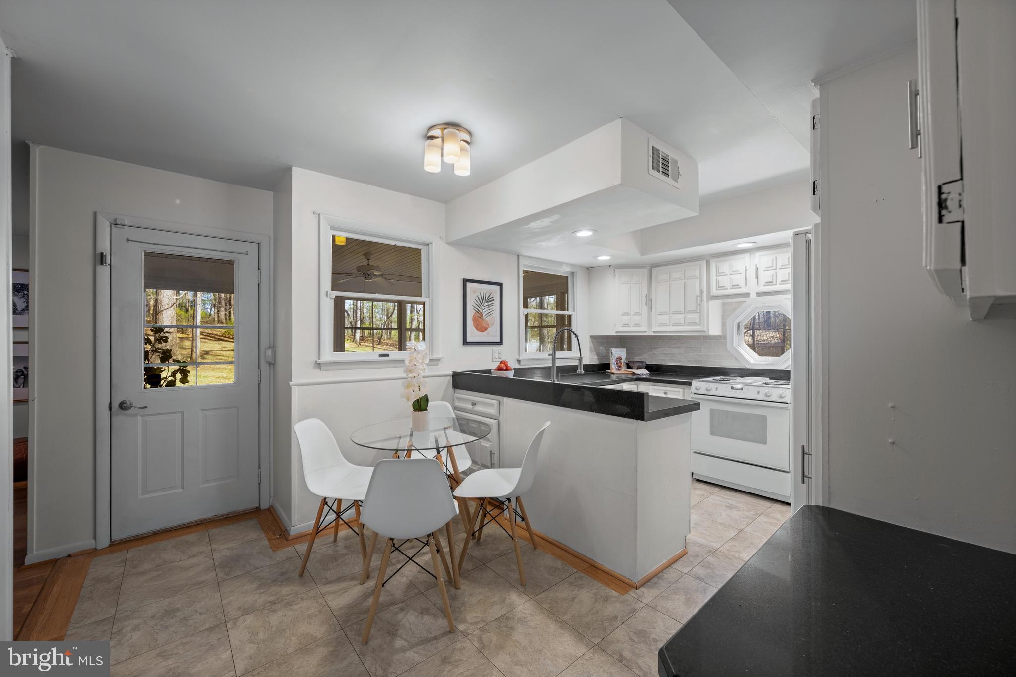 932 Western Chapel Road Westminster, MD 21157 - Photo 17 of 48 a kitchen with a sink cabinets and dining table chair
