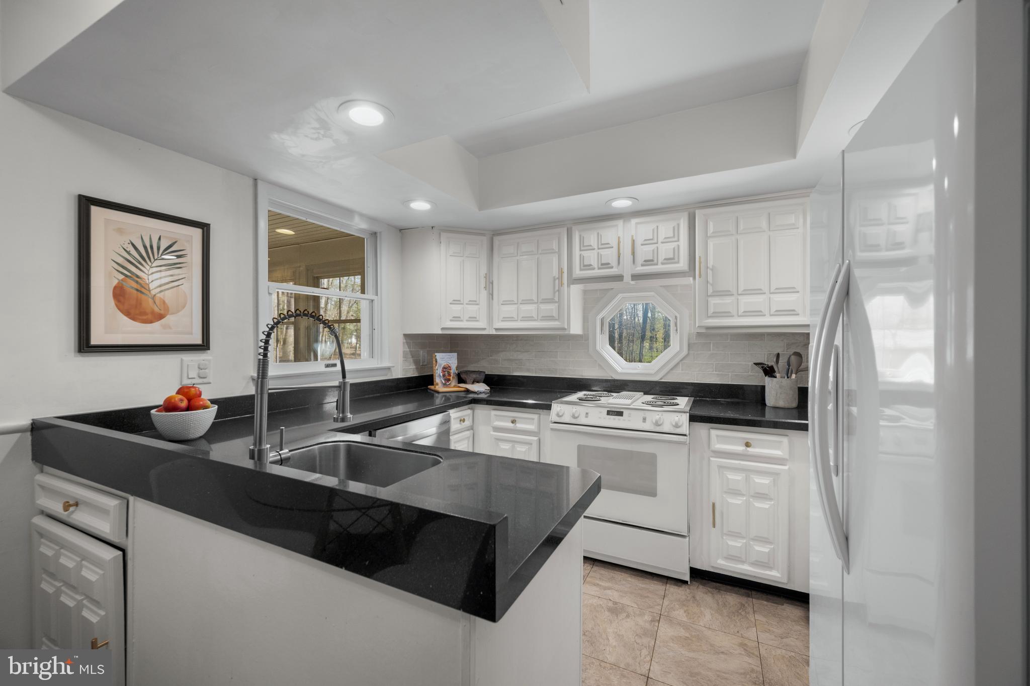 932 Western Chapel Road Westminster, MD 21157 - Photo 10 of 48 a kitchen with stainless steel appliances granite countertop a sink stove and cabinets