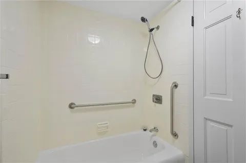 a bathroom with a bath tub with a shower