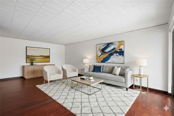 a living room with furniture and wooden floor