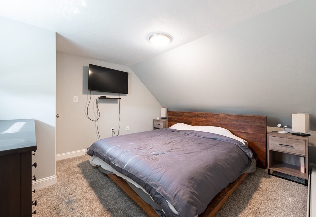 8 Putnam Street, Unit 3 Danvers, MA 01923 - Photo 15 of 32 a bedroom with a bed and a flat screen tv