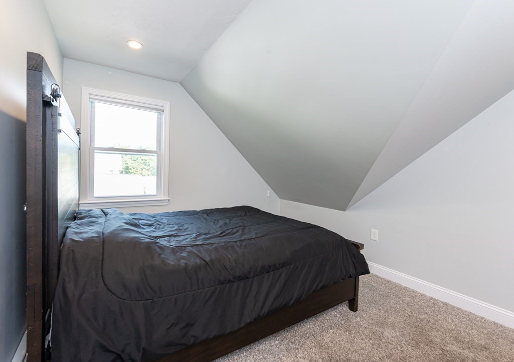 8 Putnam Street, Unit 3 Danvers, MA 01923 - Photo 19 of 32 a bedroom with a bed and a window