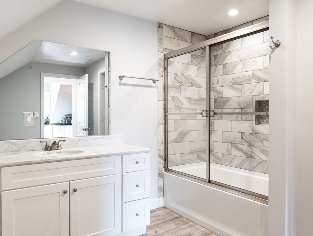 8 Putnam Street, Unit 3 Danvers, MA 01923 - Photo 22 of 32 a bathroom with a shower sink vanity and mirror