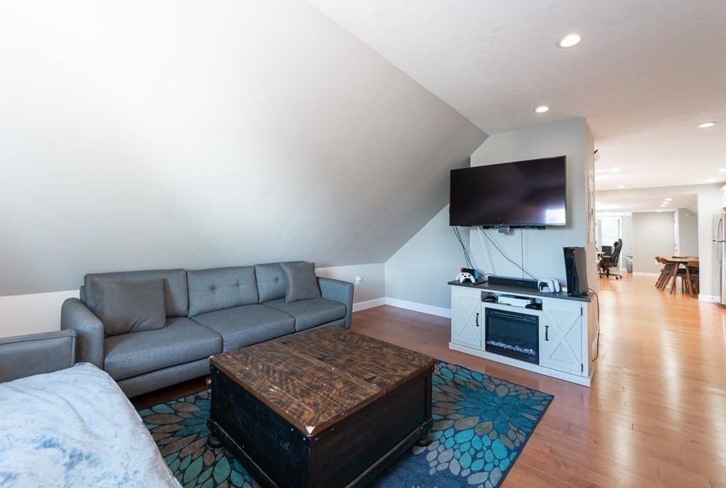 8 Putnam Street, Unit 3 Danvers, MA 01923 - Photo 6 of 32 a living room with furniture and a flat screen tv