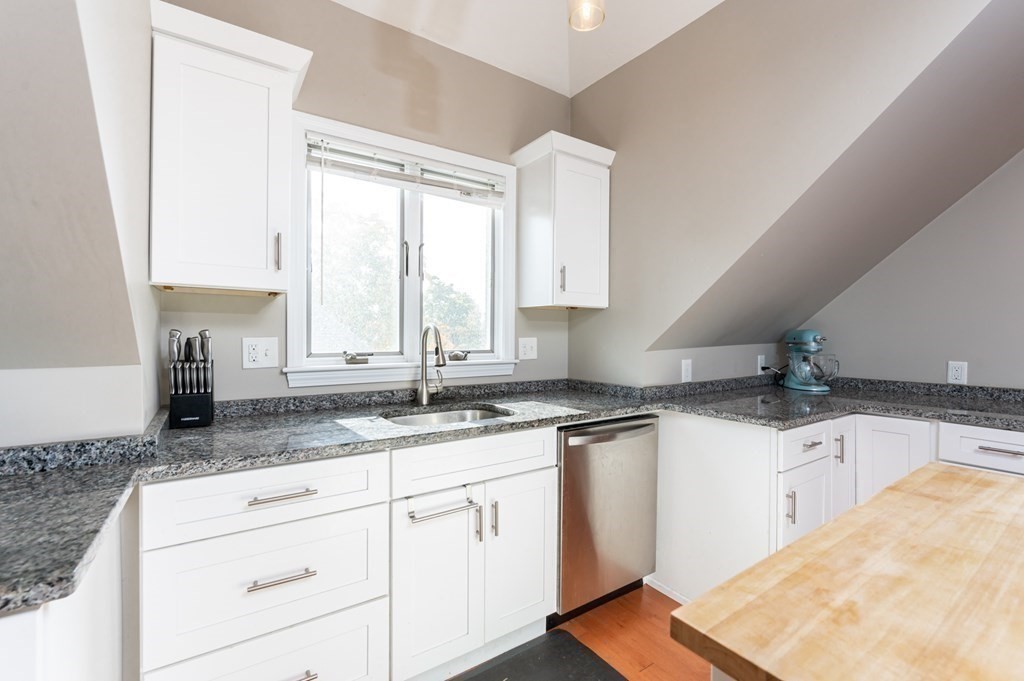 8 Putnam Street, Unit 3 Danvers, MA 01923 - Photo 8 of 32 a kitchen with granite countertop a sink stove and cabinets