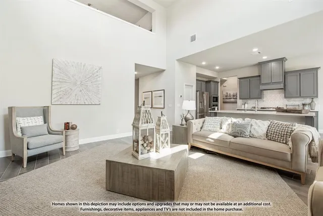 a living room with furniture and a dining table with kitchen view