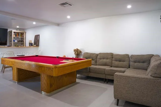 a living room with furniture and kitchen view