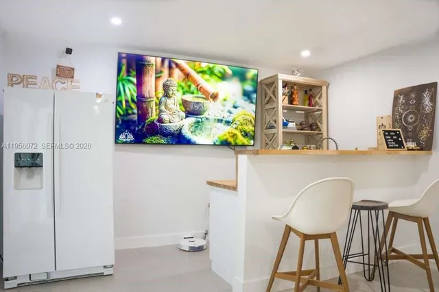 a view of a dining room with furniture and a potted plant