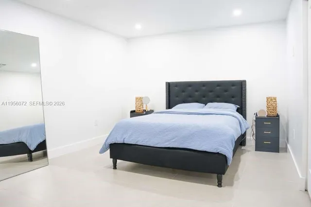 a bedroom with a bed and a night stand