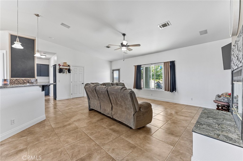 2700 Olivera Road Pinon Hills, CA 92371 - Photo 11 of 37 a living room with furniture and a chandelier