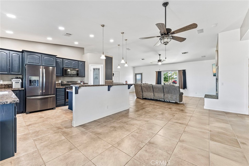 2700 Olivera Road Pinon Hills, CA 92371 - Photo 13 of 37 a large white kitchen with a refrigerator a stove top oven and a sink