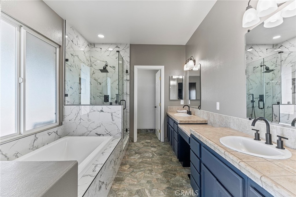 2700 Olivera Road Pinon Hills, CA 92371 - Photo 19 of 37 a spacious bathroom with a bathtub shower sink double and mirror