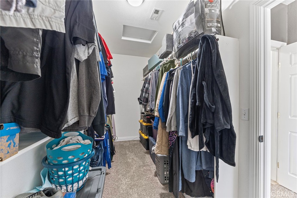 2700 Olivera Road Pinon Hills, CA 92371 - Photo 21 of 37 a view of walk in closet with clothes and shoes