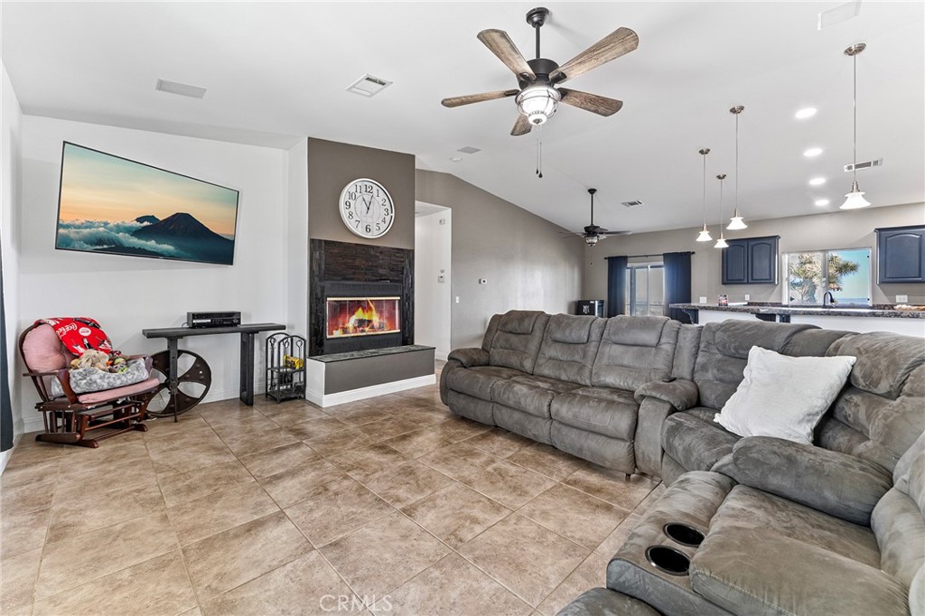 2700 Olivera Road Pinon Hills, CA 92371 - Photo 10 of 37 a living room with furniture and a flat screen tv