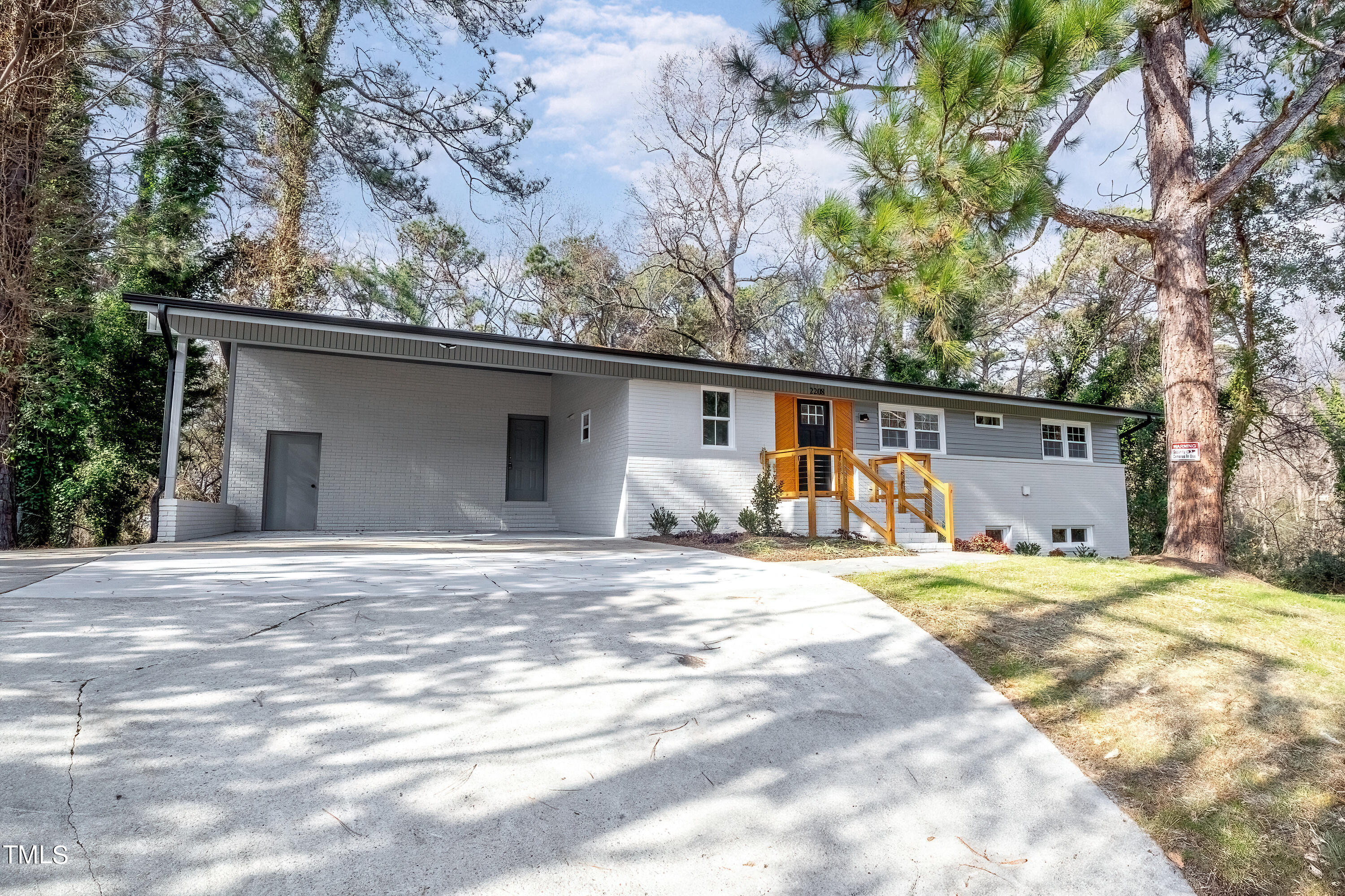 2208 Sanderford Road Raleigh, NC 27610 - Photo 4 of 75 a front view of a house with a yard and garage
