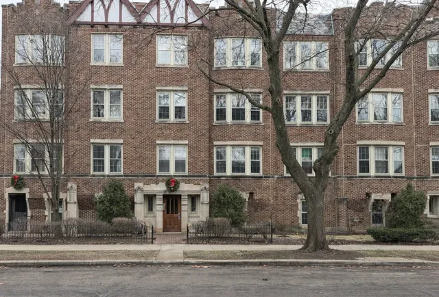 a view of a brick building next to a road