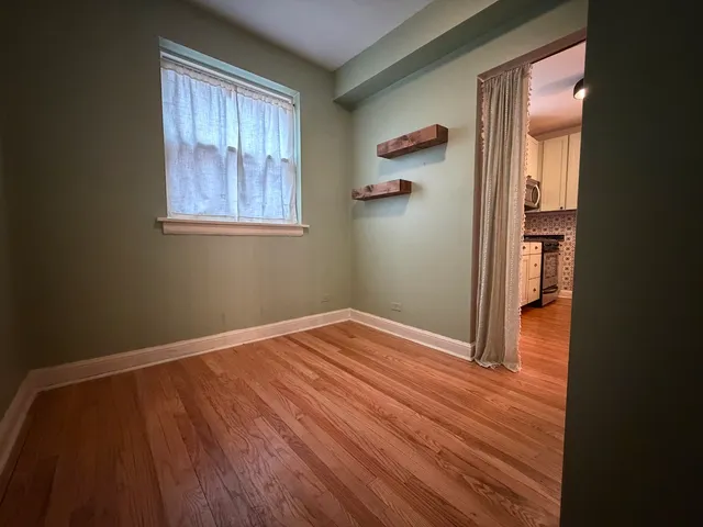 a view of room with window and wooden floor