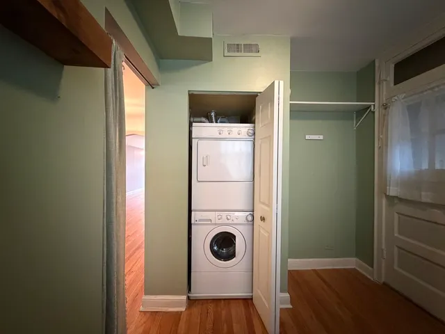 a view of a walk in closet and wooden door
