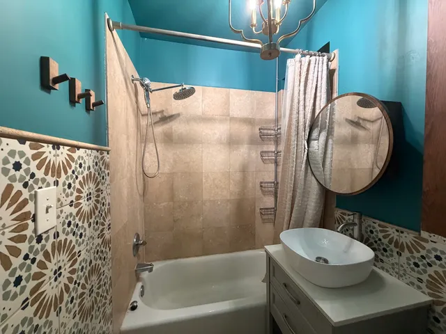 a bathroom with a sink toilet and shower
