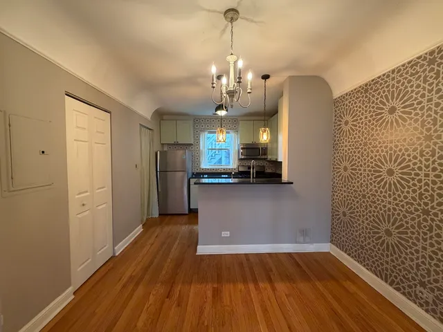 a view of a kitchen with a sink and refrigerator