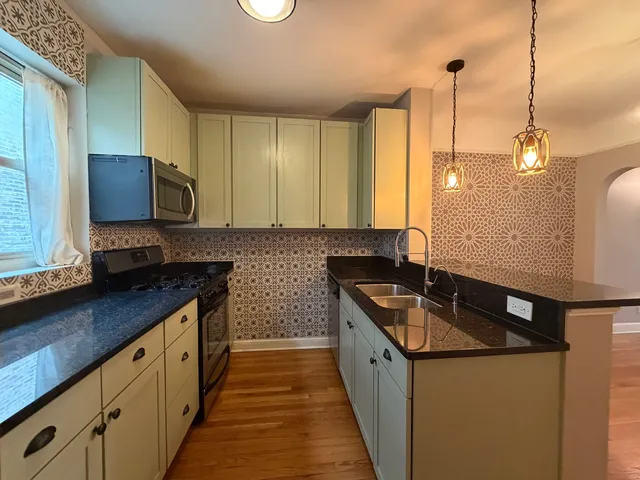 a kitchen that has a sink and a stove in it