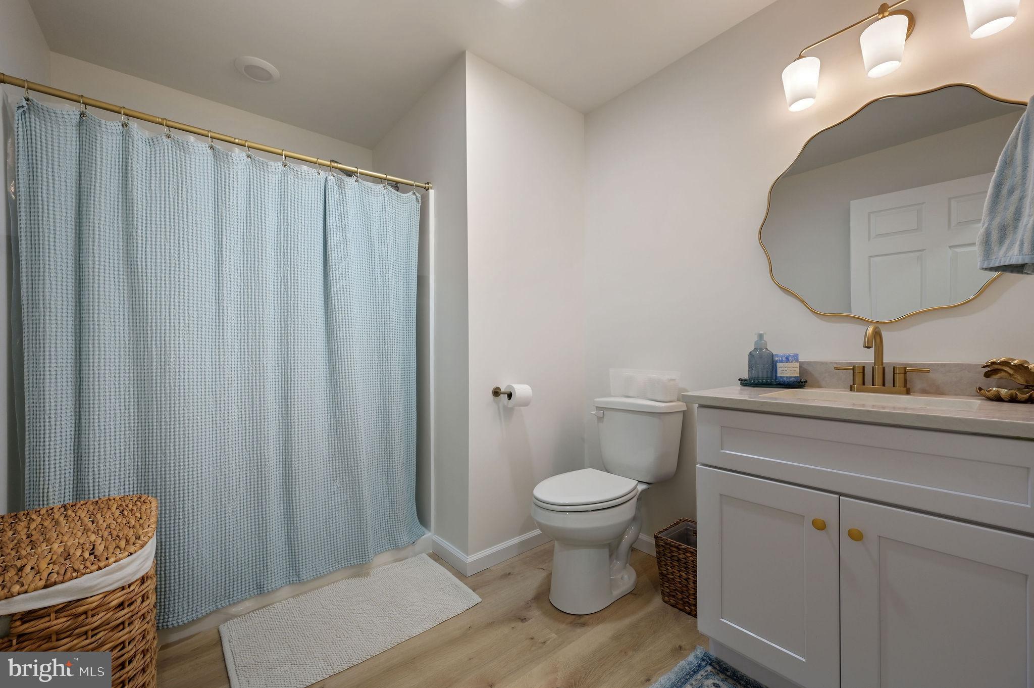 7 Porter Street Harrington, DE 19952 - Photo 16 of 24 a bathroom with a sink toilet a mirror and vanity