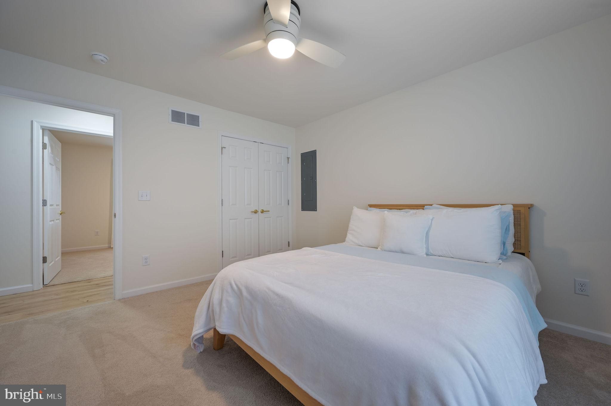 7 Porter Street Harrington, DE 19952 - Photo 20 of 24 a bedroom with a bed and a chandelier