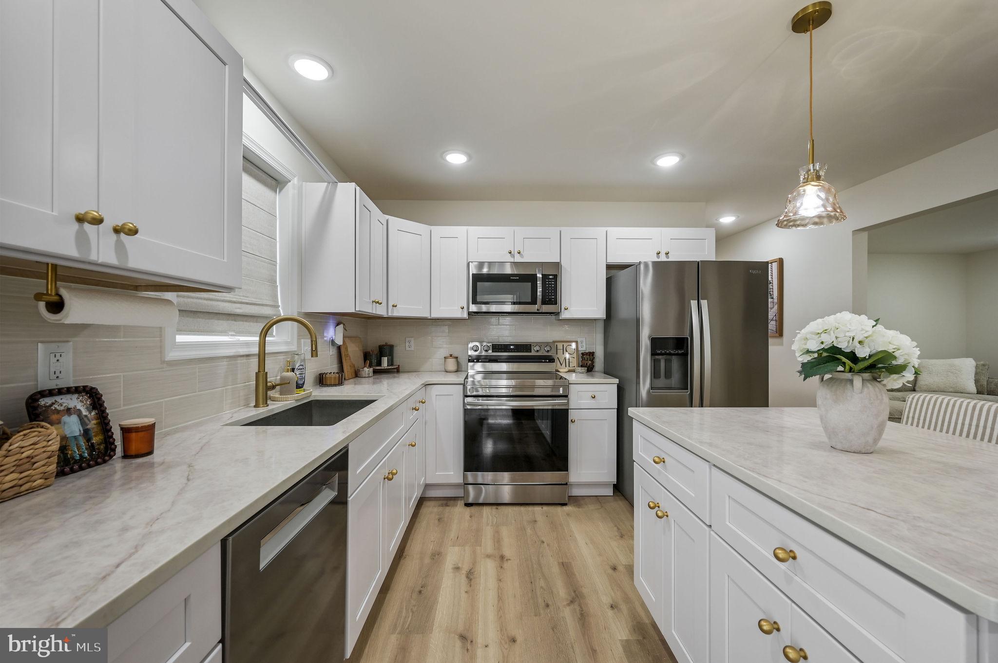 7 Porter Street Harrington, DE 19952 - Photo 2 of 24 a kitchen with kitchen island granite countertop a sink stainless steel appliances and cabinets