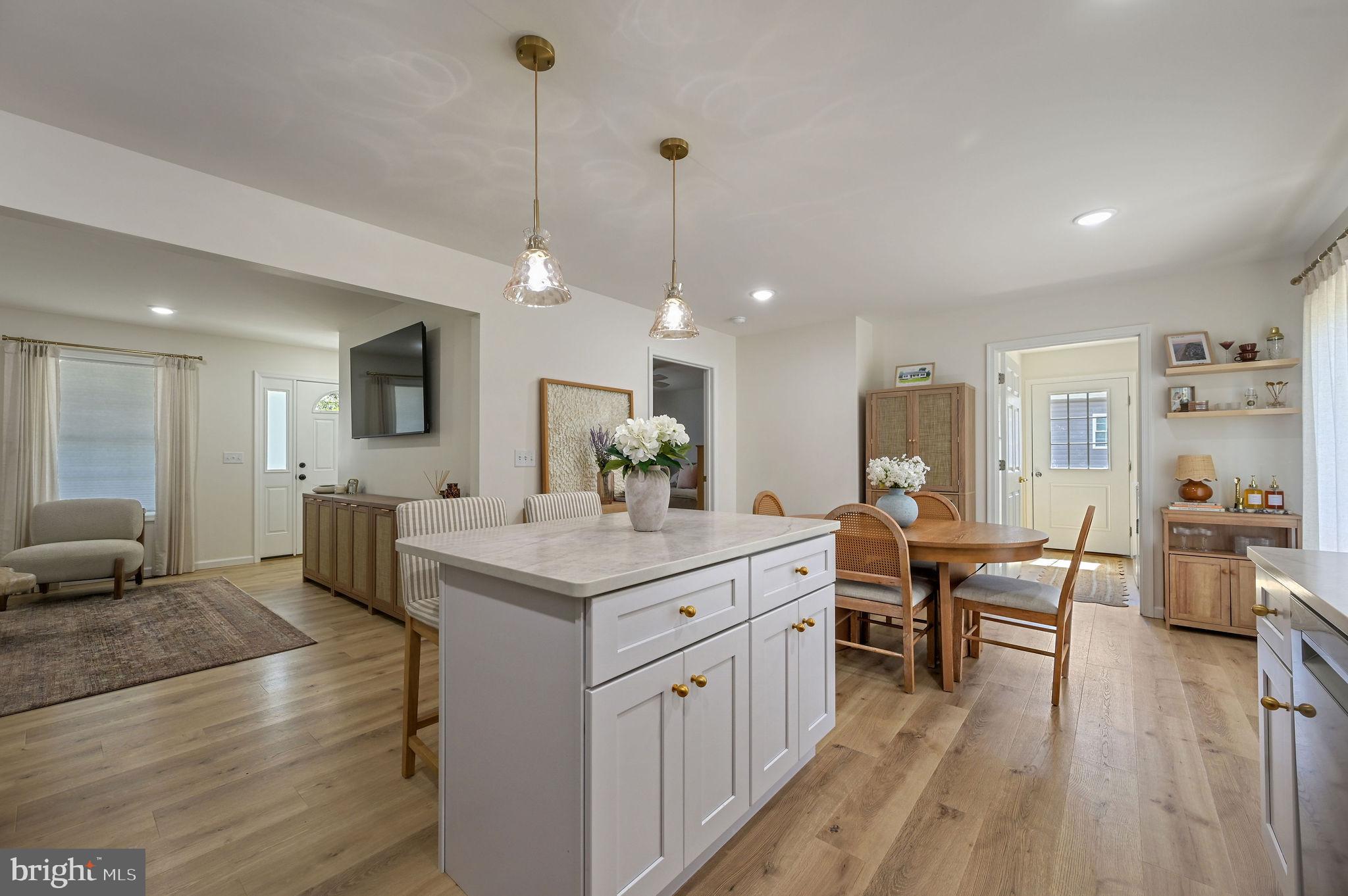 7 Porter Street Harrington, DE 19952 - Photo 5 of 24 a large kitchen with kitchen island a white counter space a sink and living room view