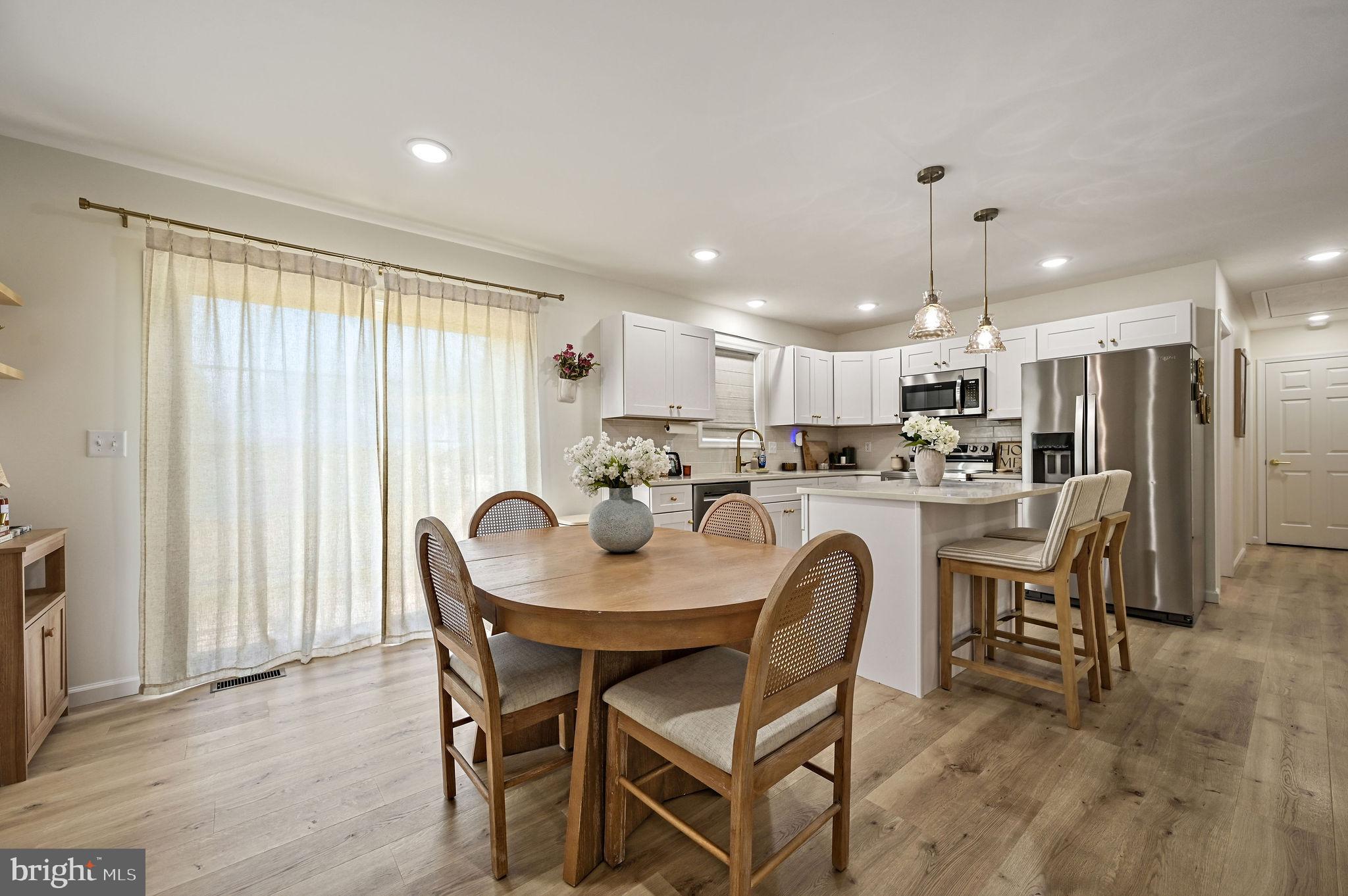 7 Porter Street Harrington, DE 19952 - Photo 8 of 24 a kitchen with kitchen island a dining table and chairs