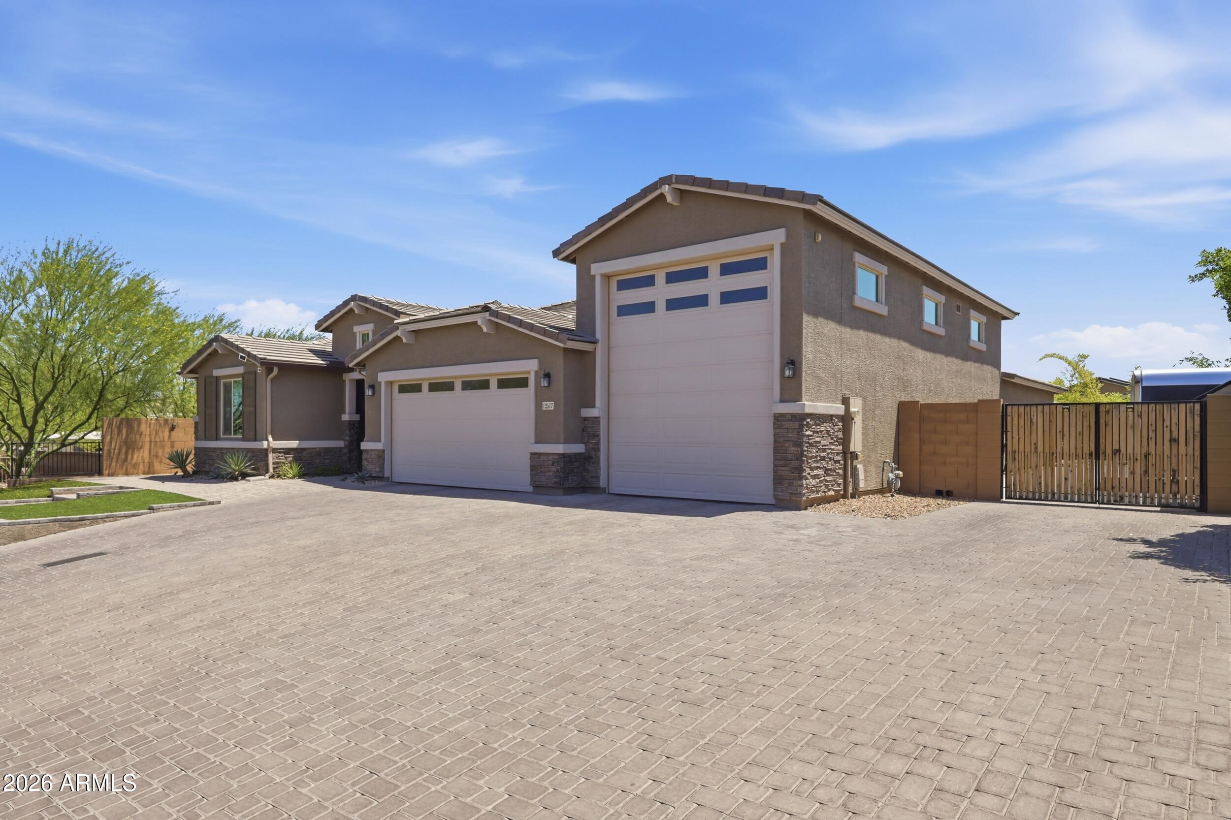 12517 West Lawrence Road Glendale, AZ 85307 - Photo 7 of 52 a front view of a house with a yard and garage